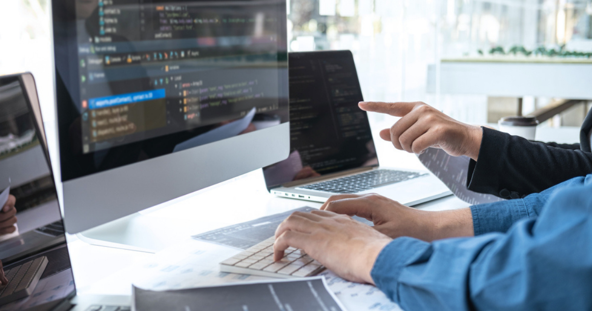 Outsource developer working with computers in an office