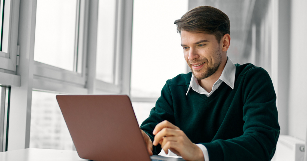 young man with his laptop at an online meeting related to software development